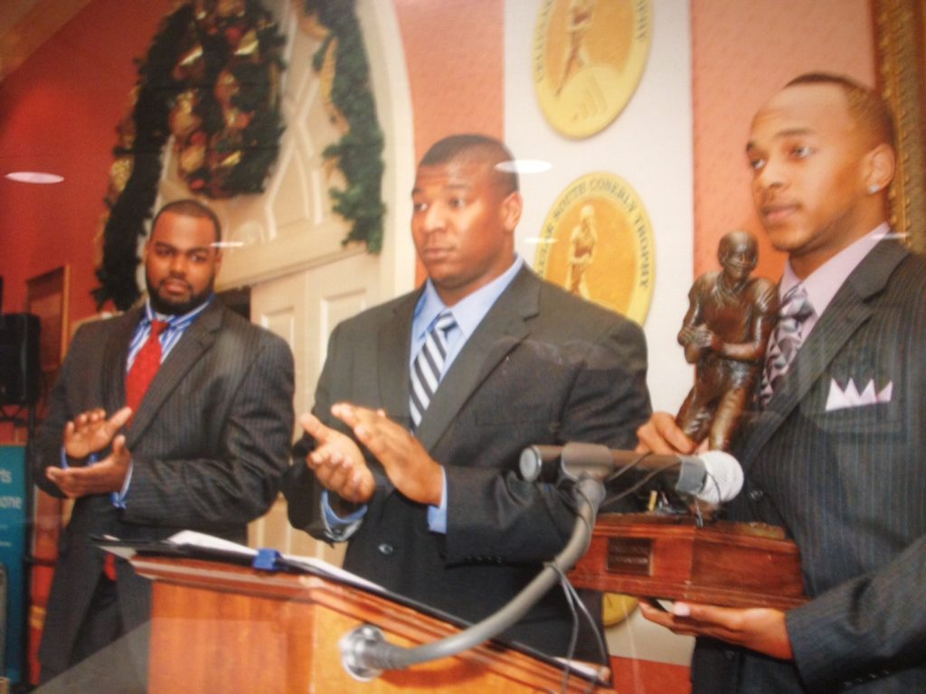 Juan Joseph, far right, with 2008 C Spire Conerly Trophy as Mike Oher, far left, and Peria Jerry look on.