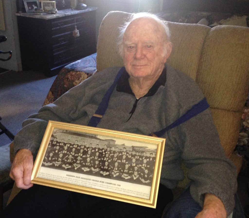 Tut Patterson, 93, holds his prized photo of Mississippi State's 1941 Orange Bowl team.