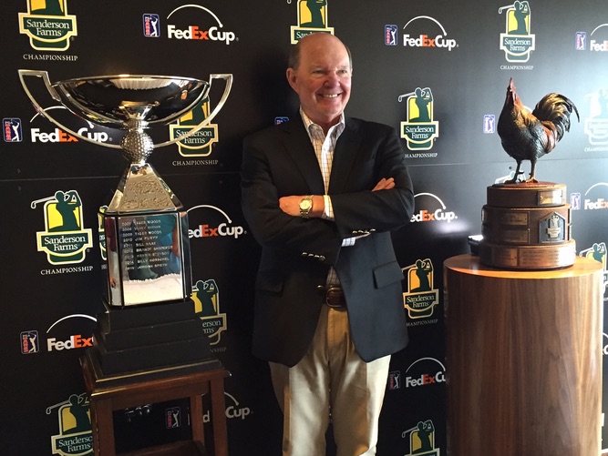 Joe Sanderson, with Fed Ex Cup Trophy on left and Sanderson Farms Championship trophy on right.