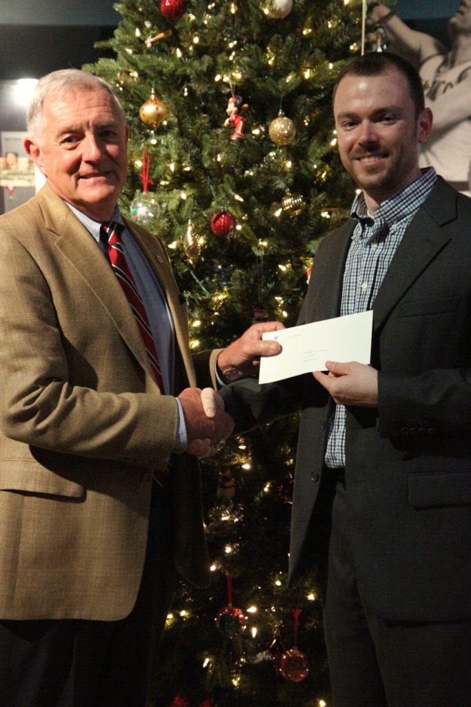 Clarion-Ledger publisher Nathan Edwards, right, presents a check to Bill Blackwell, Chief Operations Officer of the Mississippi Sports Hall of Fame and Museum. 