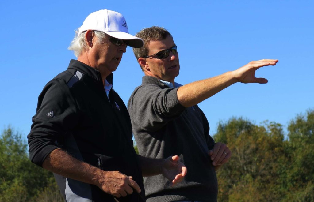 Gil Hanse (right) makes a point to George Bryan during the construction of Mossy Oak golf course.